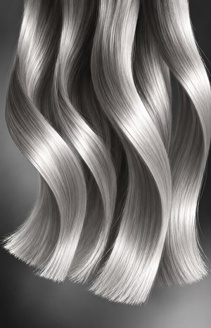 Close-up of long glossy hair strands with sleek flowing waves showing healthy trimmed ends, in dramatic black-and-white