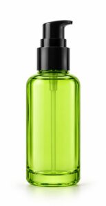 Fresh green tinted glass bottle of cleansing lotion with black pump, centred on white