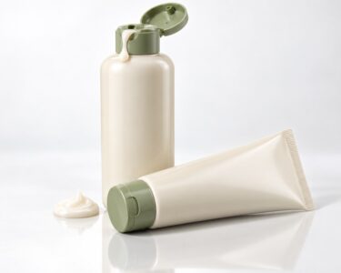 Repair shampoo bottle and matching conditioner tube side by side, three-quarter angle on white studio background