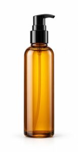 Tall slim bottle of nourishing hair oil with a pump dispenser, centred and hanging-style vertical composition on white