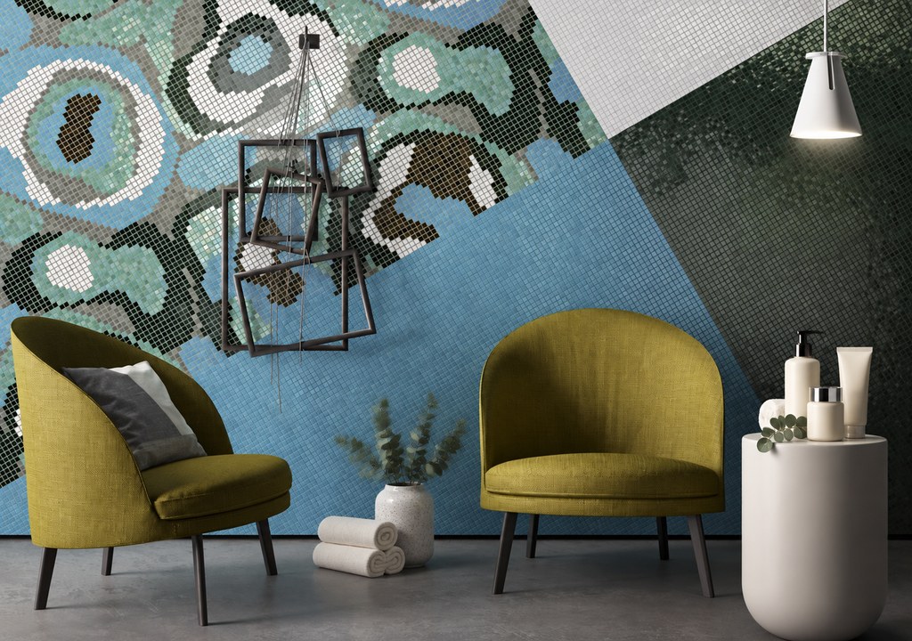 Two olive-green salon armchairs against a blue and green mosaic wall with a styling product display on a white side tabl