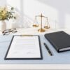 Neatly arranged desk still life of a signed commercial contract, pen and folder, representing a lease or agreement revie