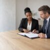 Two South African lawyers reviewing a shareholder agreement together in a bright meeting room