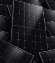 Full Black Solar Panel 410W nestled among other stacked black solar panels showing cell texture