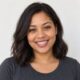 Smiling mixed-heritage South African woman with shoulder-length hair, customer avatar