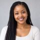 Smiling young South African woman with long braids, customer headshot